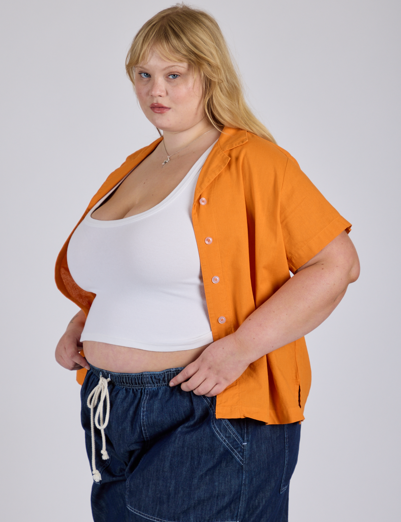 Angled front view of Pantry Button-Up in Creamsicle Orange on Juliet