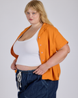 Angled front view of Pantry Button-Up in Creamsicle Orange on Juliet