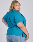Angled back view of Pantry Button-Up in Hawaiian Blue on Juliet