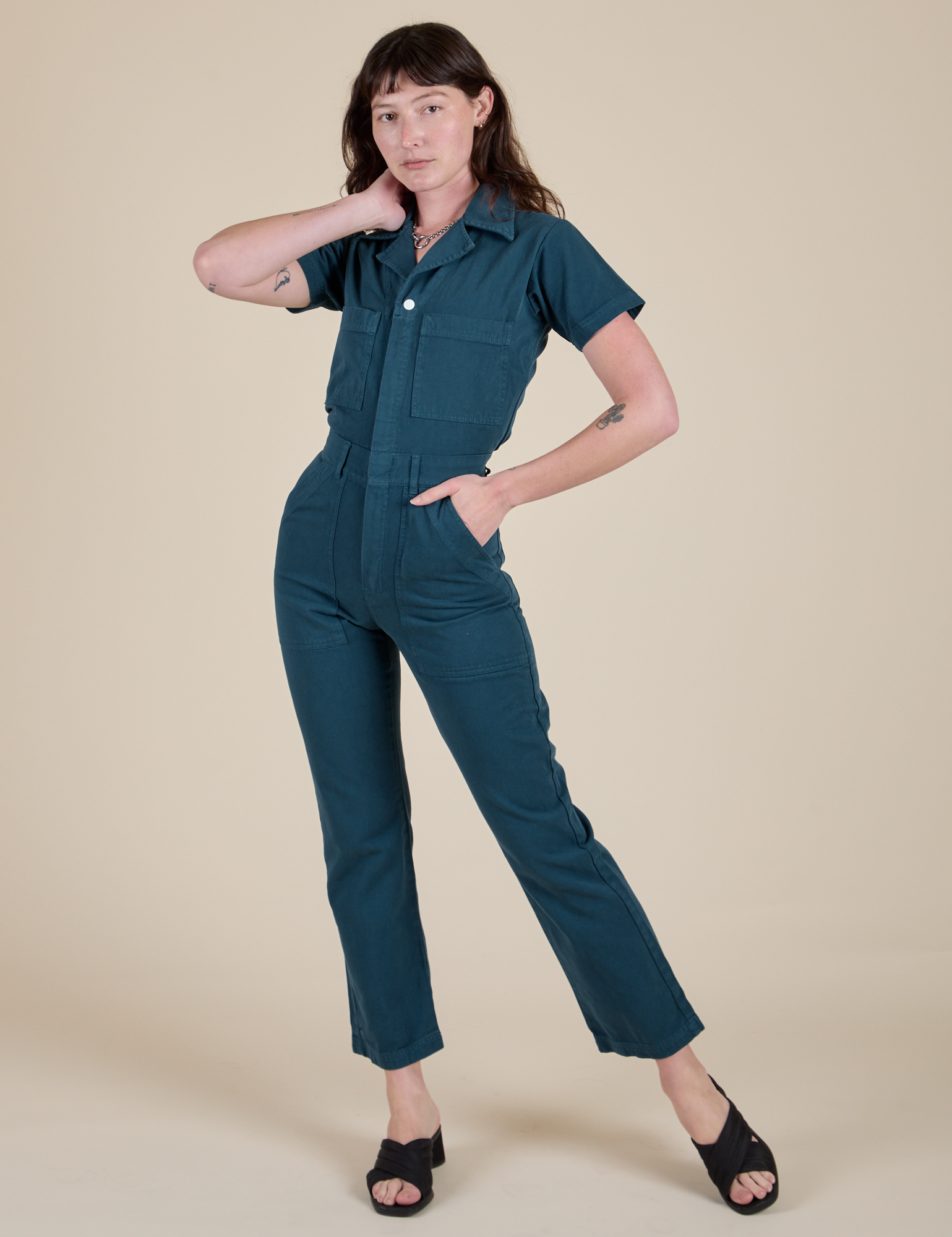 Alex is 5'8" and wearing XS Short Sleeve Jumpsuit in Lagoon