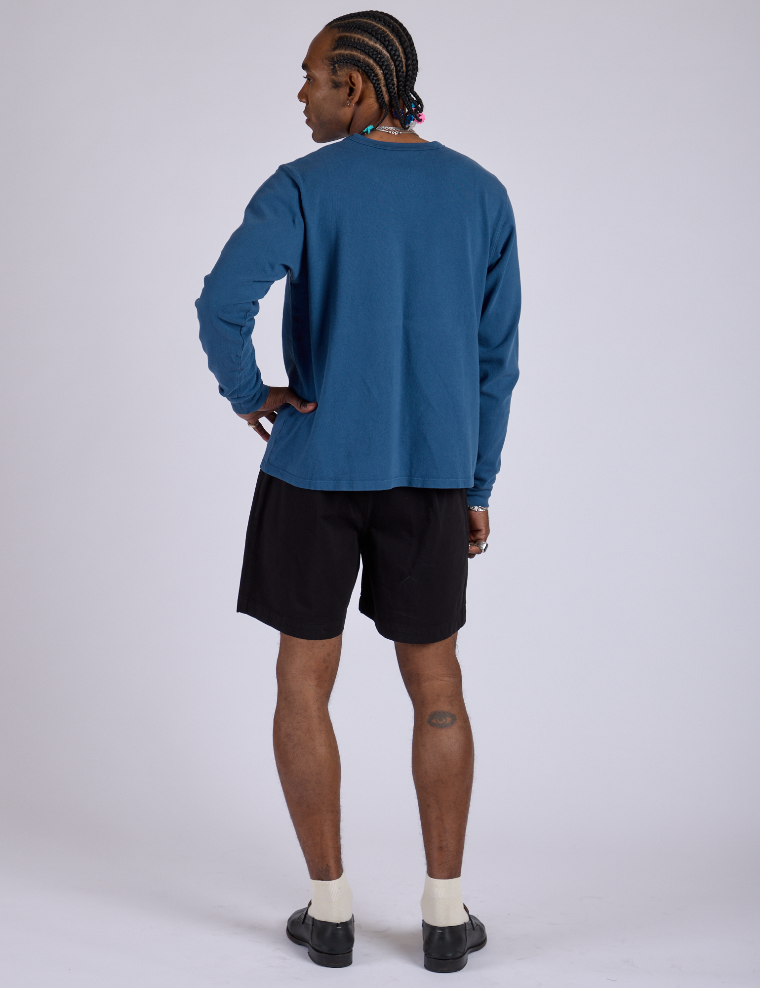 Back view of Pleated Trouser Shorts in Basic Black and Long Sleeve Burly Tee in French Blue