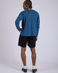 Back view of Pleated Trouser Shorts in Basic Black and Long Sleeve Burly Tee in French Blue