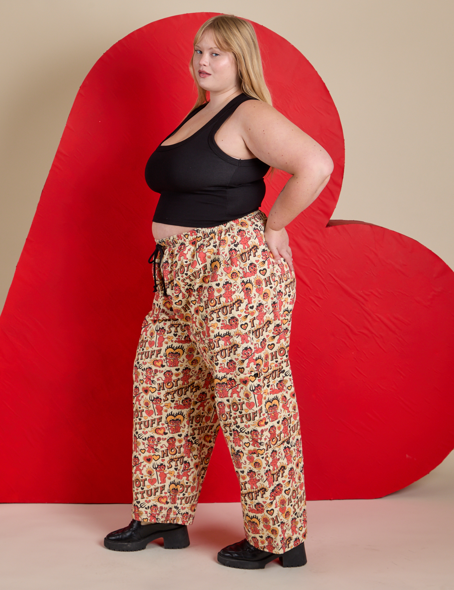 Side view of Hot Stuff Drop Pocket Cargo Pants and black Cropped Tank on Juliet