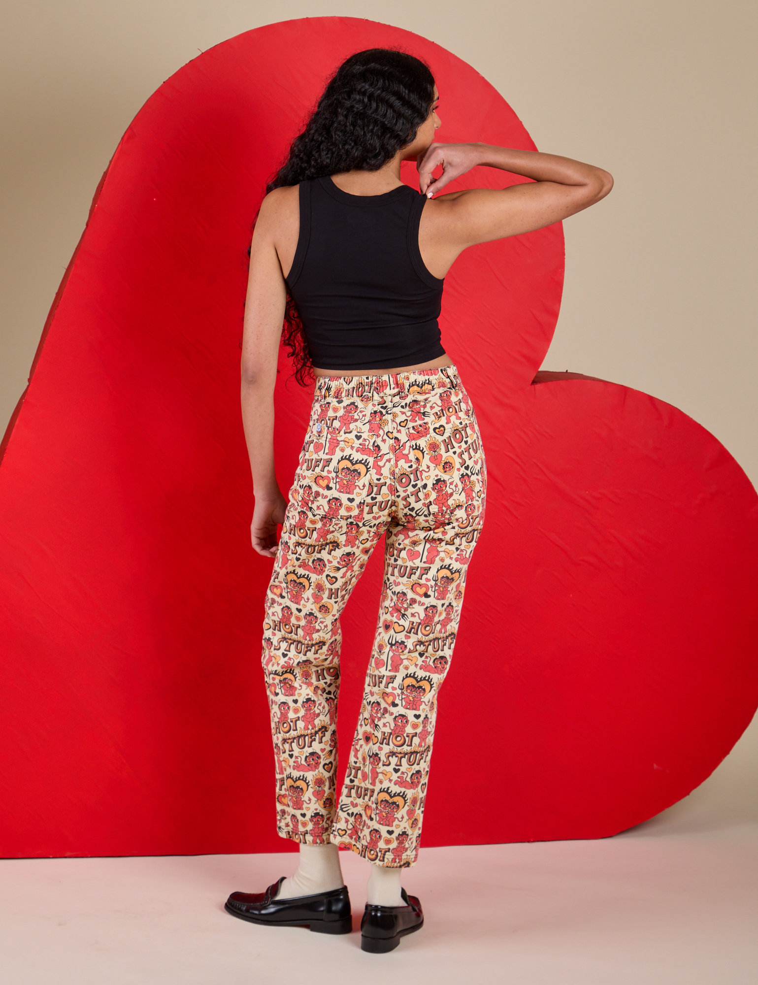 Back view of Work Pants in Hot Stuff Print and black Cropped Tank on Shahana