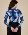 Long Sleeve Baby Tee in Blue Magic Waters back view on Alex