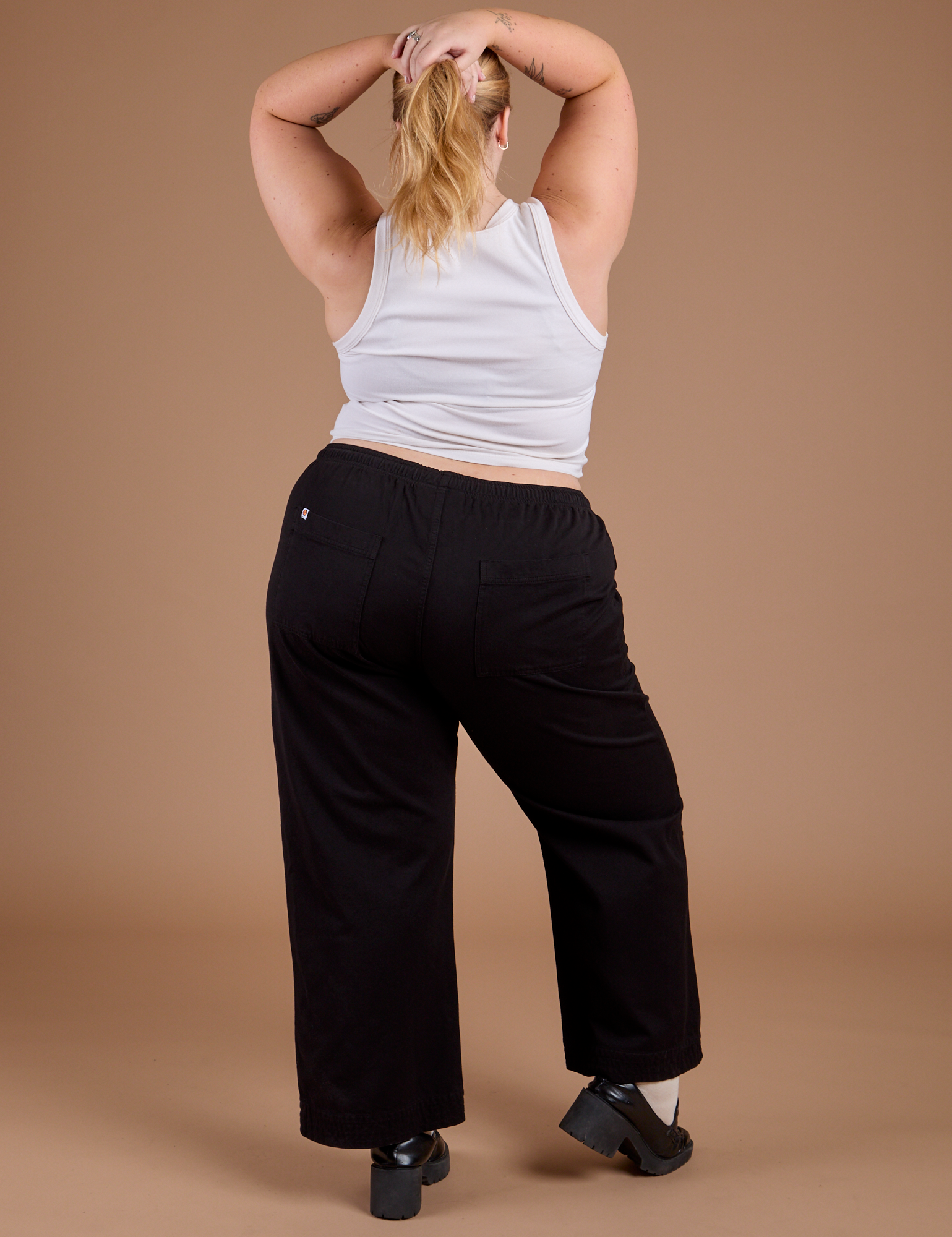 Back view of Organic Action Pants in Basic Black and vintage tee white Cropped Tank on Juliet