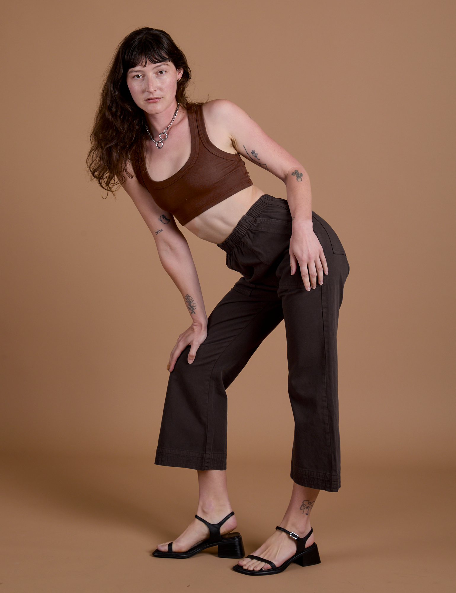 Work Pants in Espresso Brown and fudgesicle Mini Tank worn by Alex