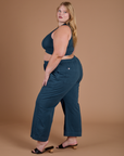 Side view of Action Pants in Lagoon and lagoon Mini Tank on Juliet
