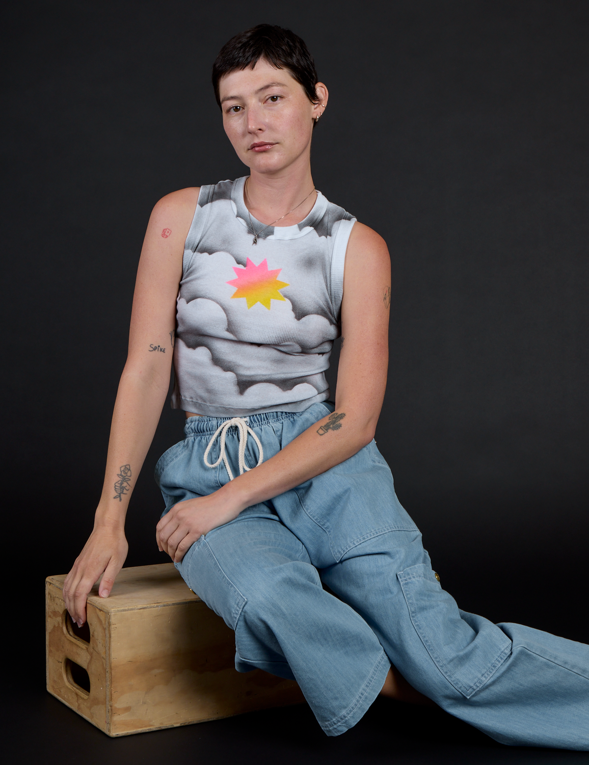 Alex wearing the Dark Cloud Airbrush Muscle Tee with Light Wash Denim Drop Pocket Pants