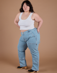 Angled front view of Carpenter Jeans in Light Wash and Cropped Tank in Vintage Tee White on Ashley