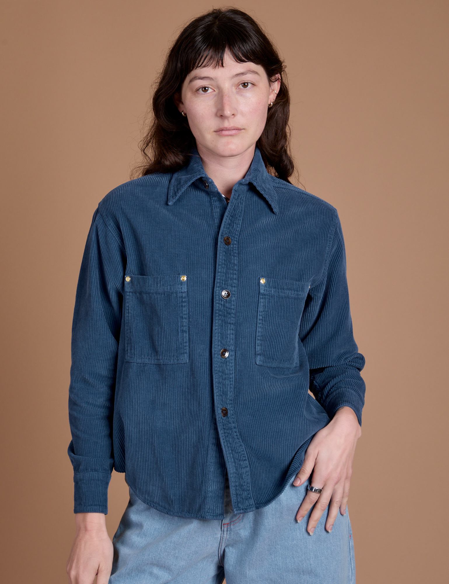 Alex is wearing a buttoned up Cropped Corduroy Overshirt in French Blue