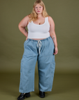 Juliet is 5’7” and wearing 2XL Denim Drop Pocket Pants in Light Wash paired with vintage tee white Cropped Tank