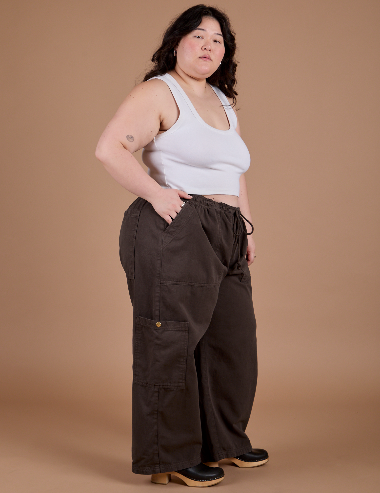 Side view of Drop Pocket Cargo Pants in Espresso Brown  and Cropped Tank in Vintage Tee White on Ashley
