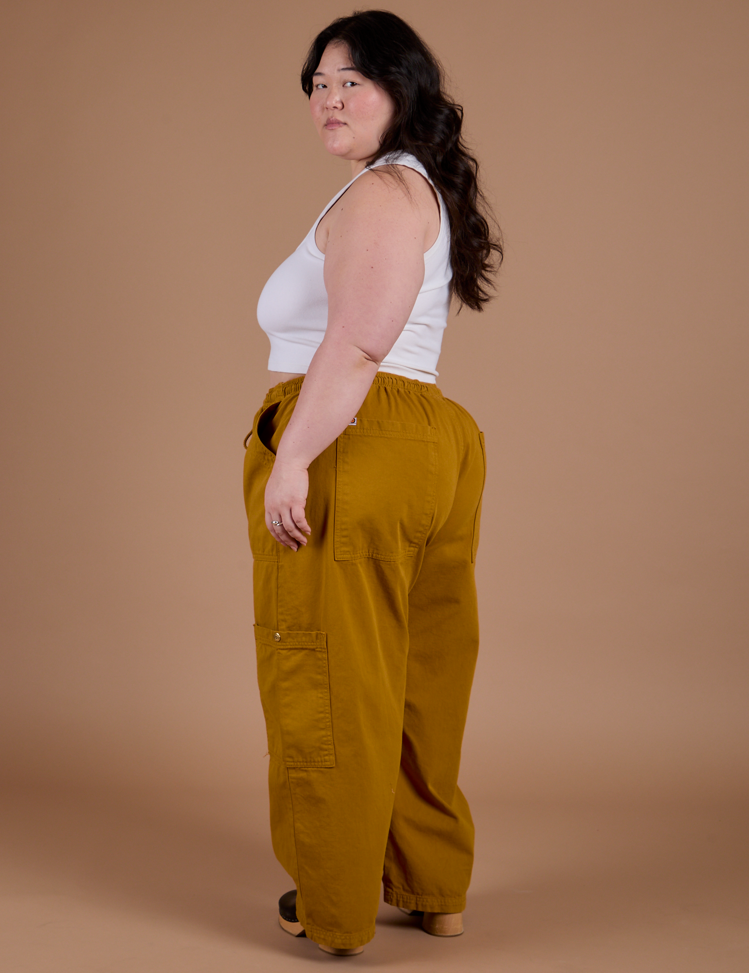 Angled back view of Drop Pocket Cargo Pants in Spicy Mustard on Ashley