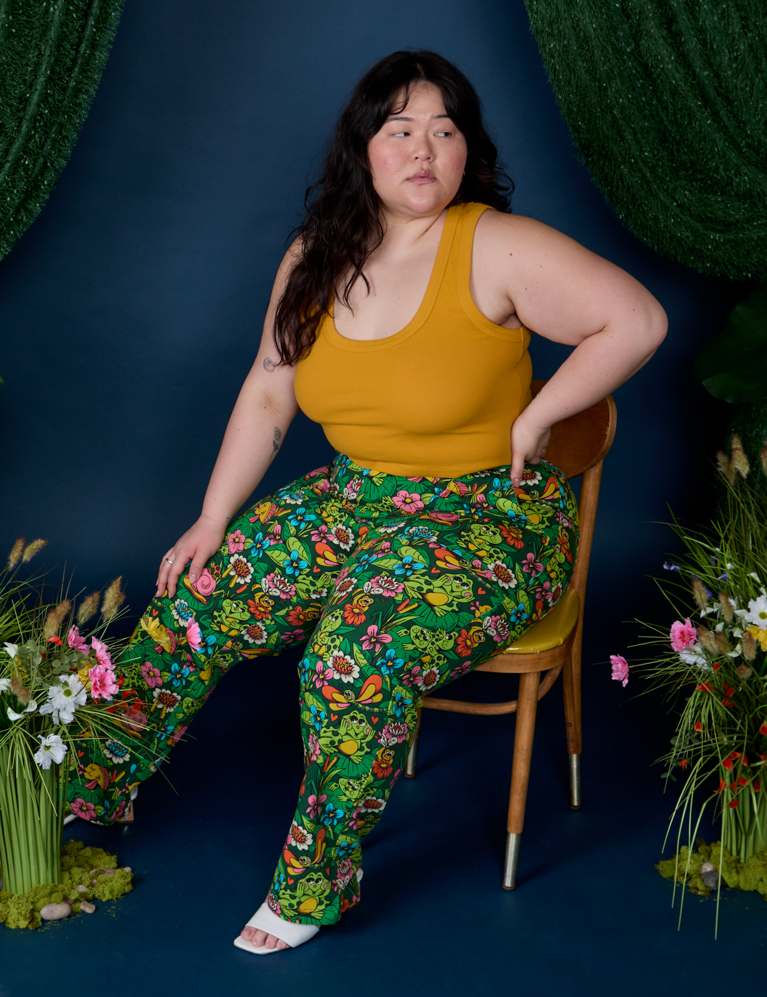 Ashley is sitting in a chair and wearing Work Pants in Pond Party