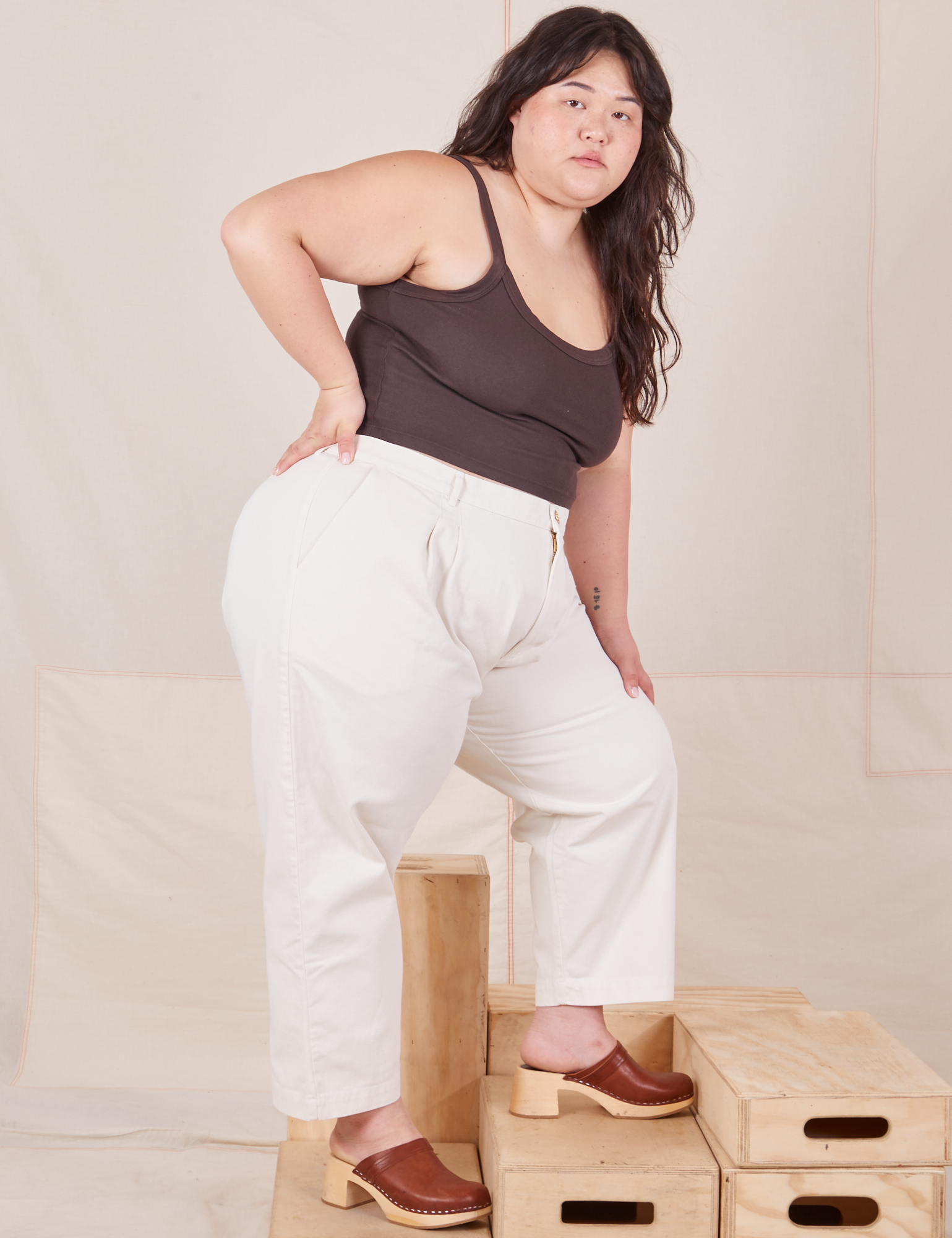 Side view of Heavyweight Trousers in Vintage Tee Off-White and espresso brown Cropped Cami worn by Ashley.