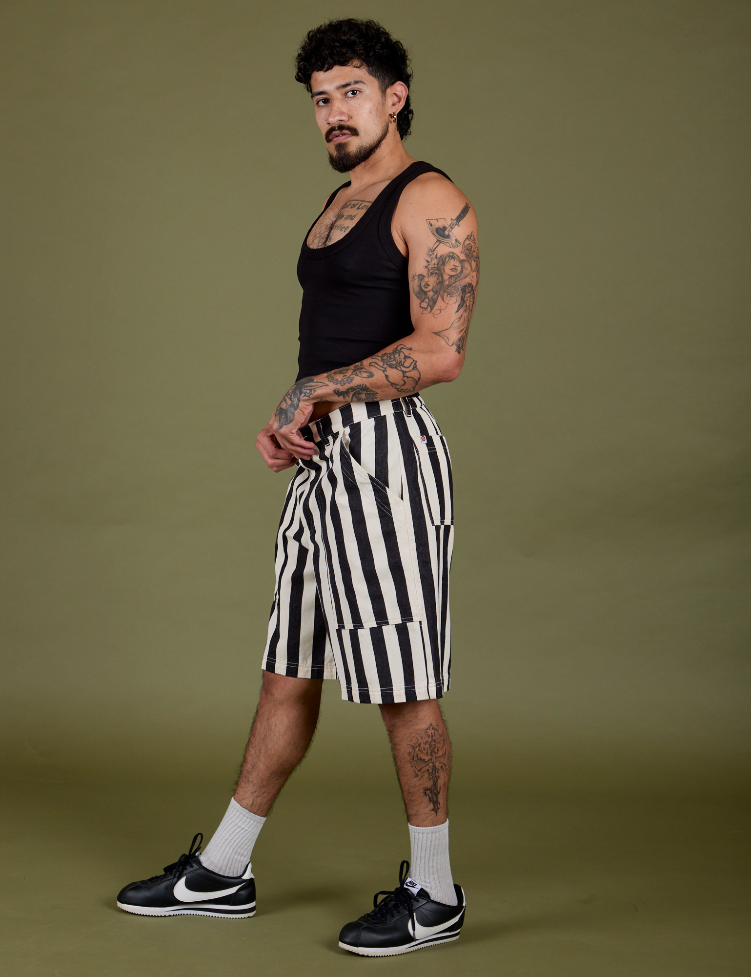 Side view of  Longline Work Shorts in Natural and black Cropped Tank on Jesse