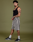 Side view of  Longline Work Shorts in Natural and black Cropped Tank on Jesse