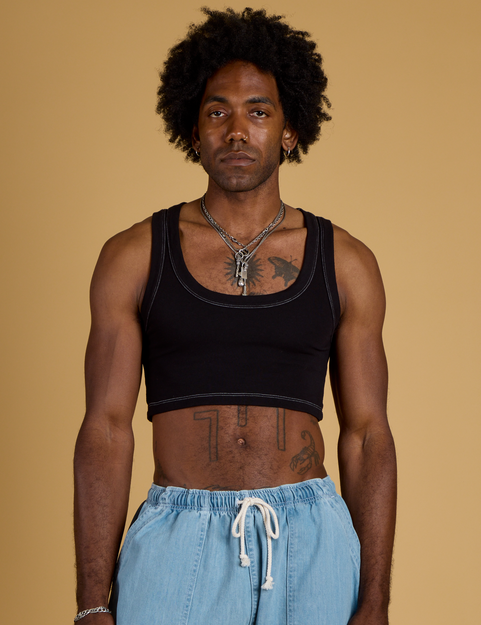 Jerrod is 6’3” and wearing M Contrast Stitch Mini Tank in Basic Black