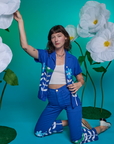 Alex is wearing Paintstamped Work Pants in Daisy and matching Pantry Button-Up