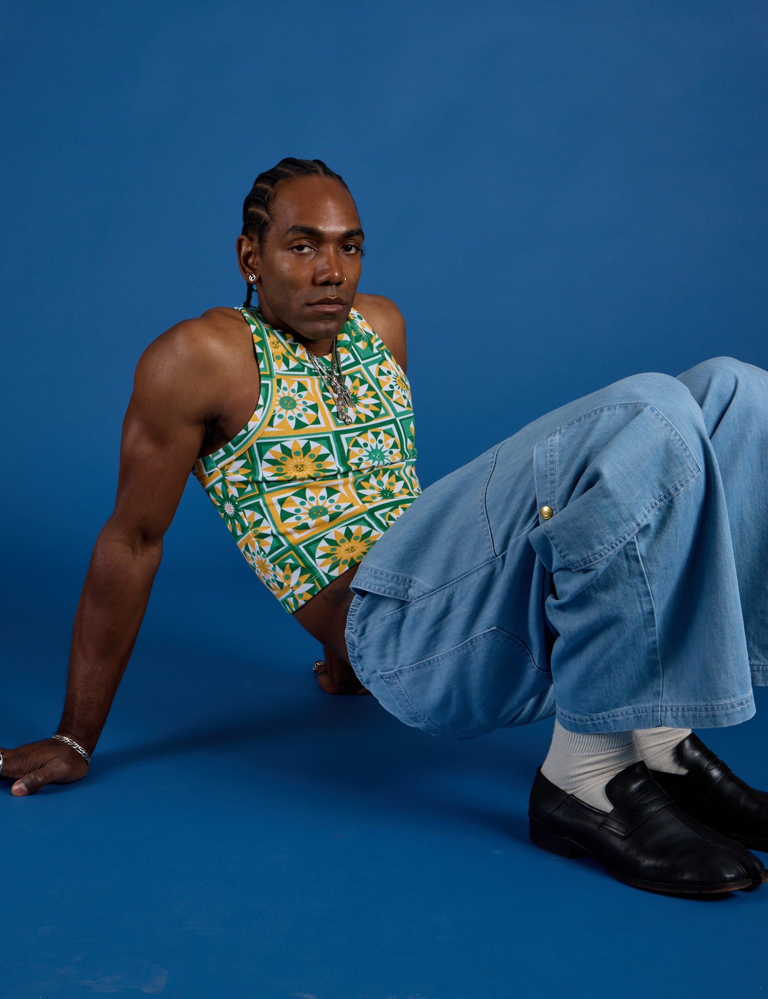 Jerrod is wearing Deep-Cut Racerback Tank in Spring Quilt Print and light wash Denim Drop Pocket Pants