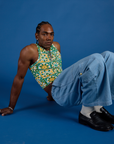 Jerrod is wearing Deep-Cut Racerback Tank in Spring Quilt Print and light wash Denim Drop Pocket Pants