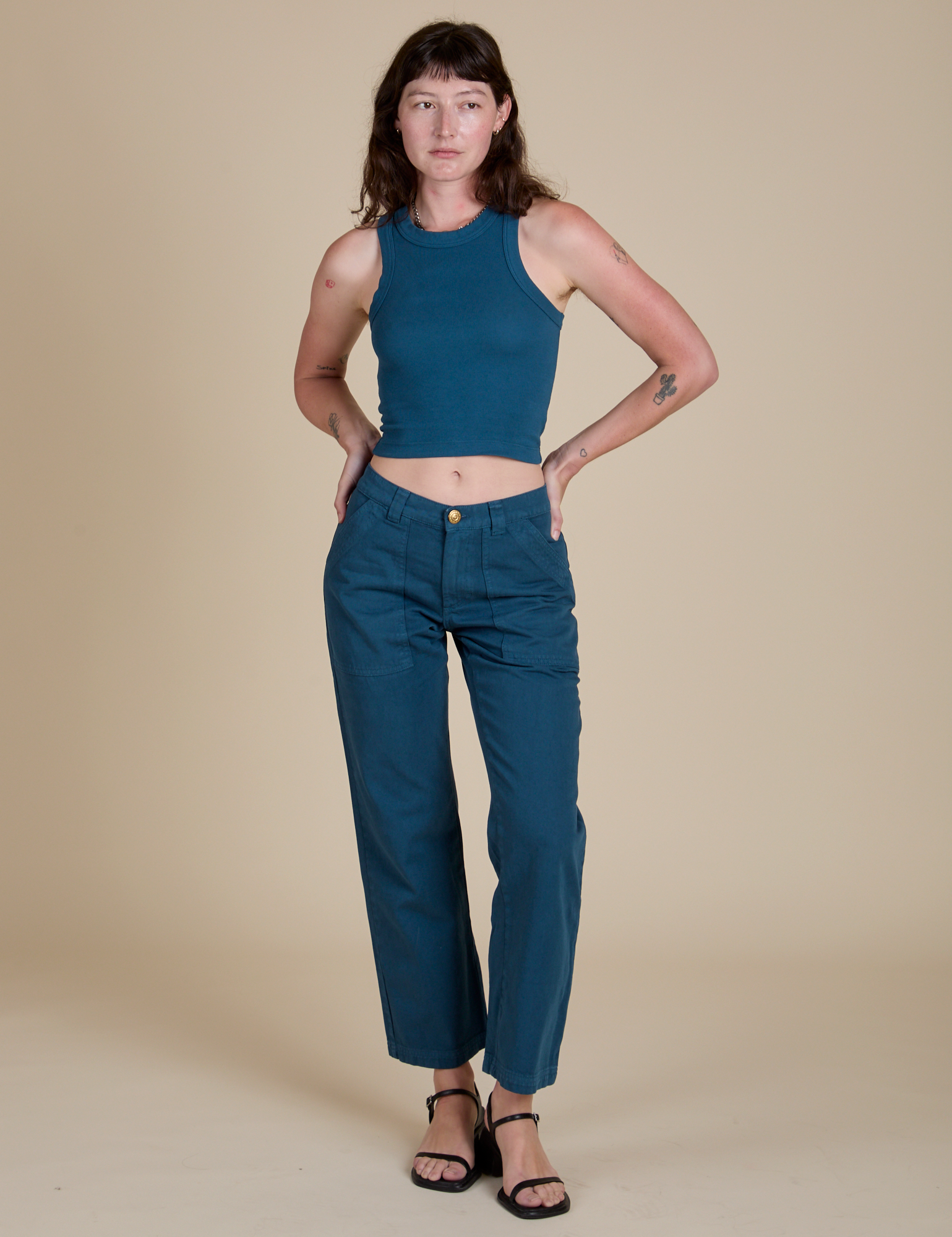 Alex is wearing Racerback Tank in Lagoon and matching Work Pants