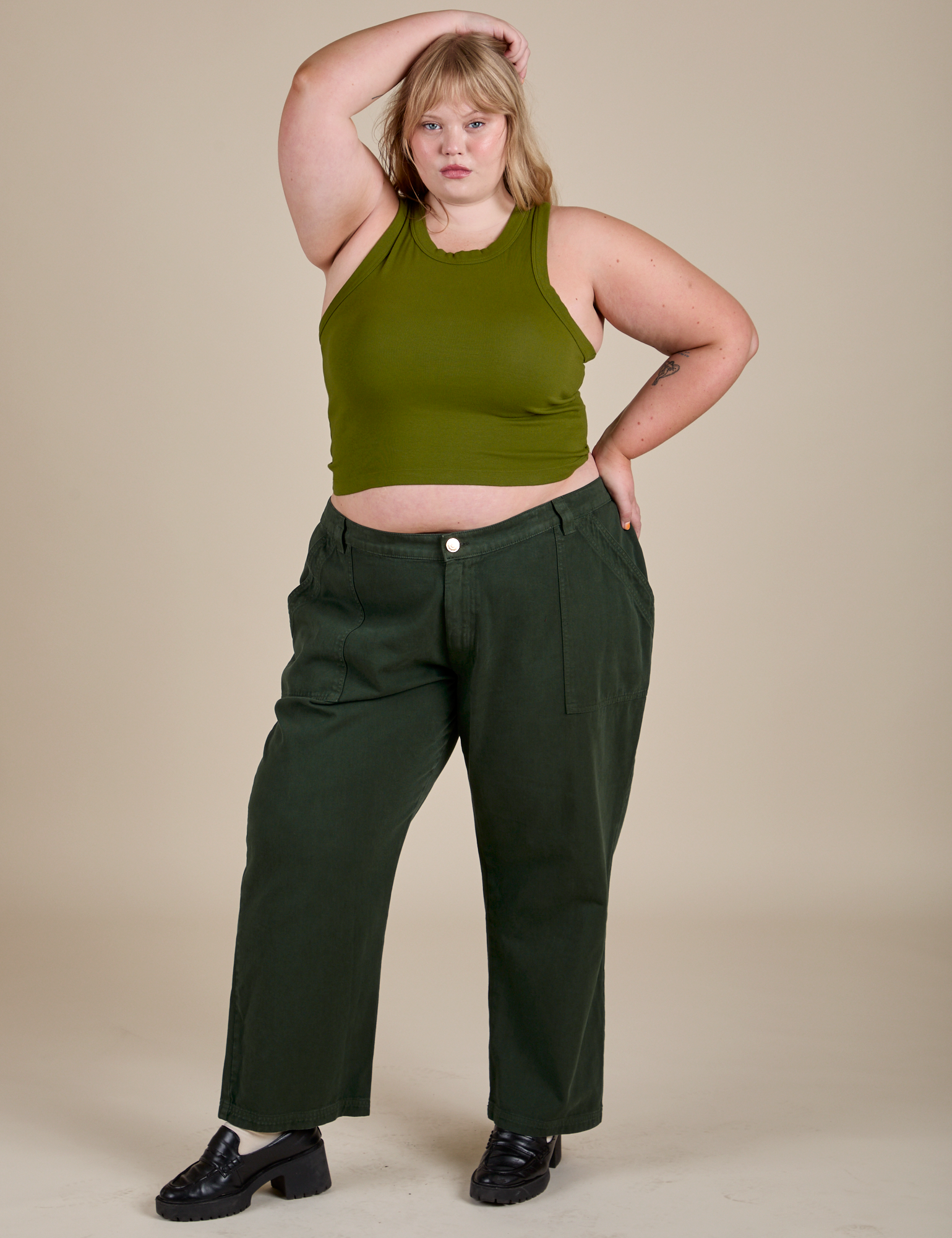 Juliet is wearing Racerback Tank in Summer Olive and swamp green Work Pants
