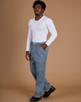 Angled front view of Railroad Denim Work Pants in Natural and vintage tee white Long Sleeve Baby Tee