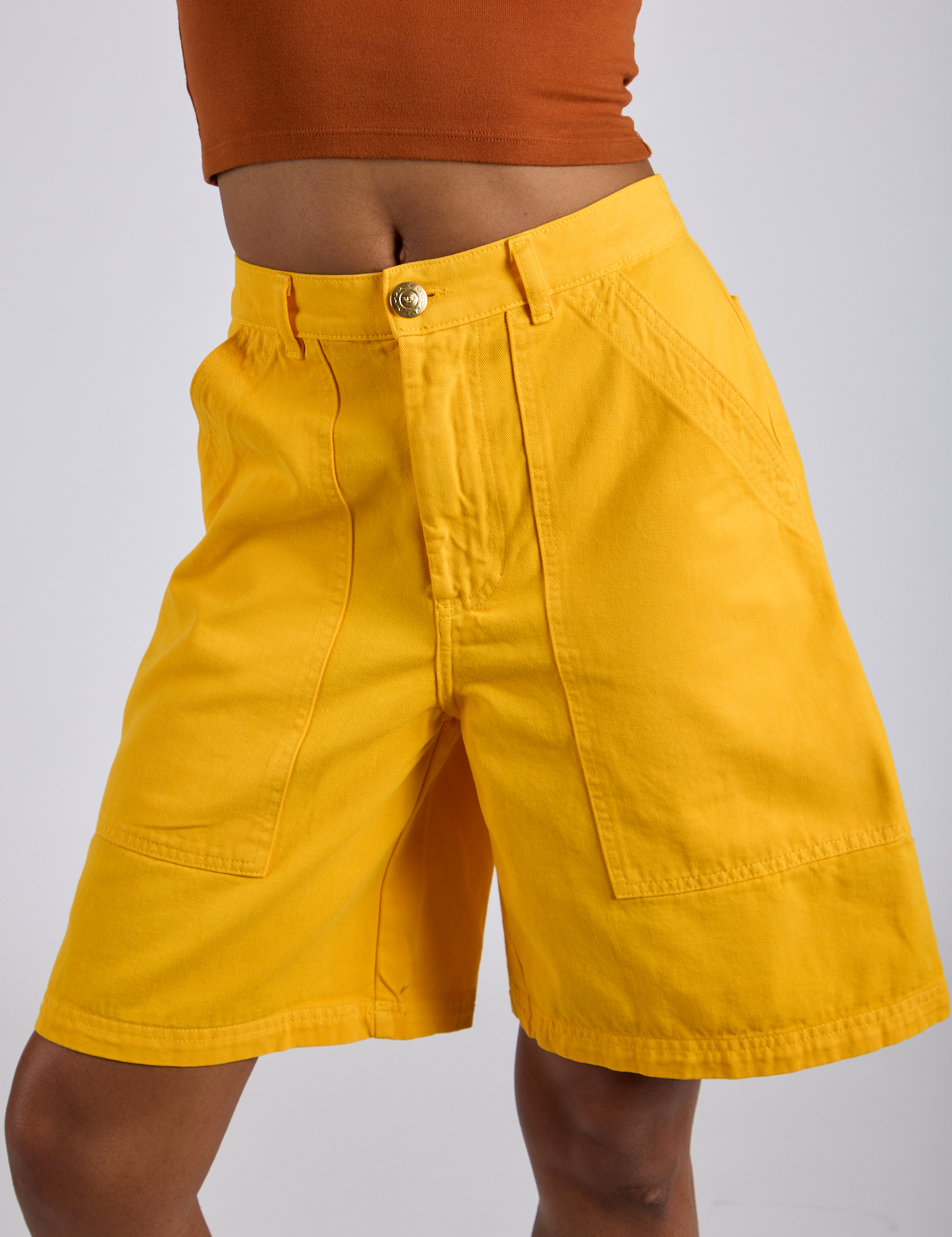 Close up of Longline Work Shorts in Sunshine Yellow on Kira