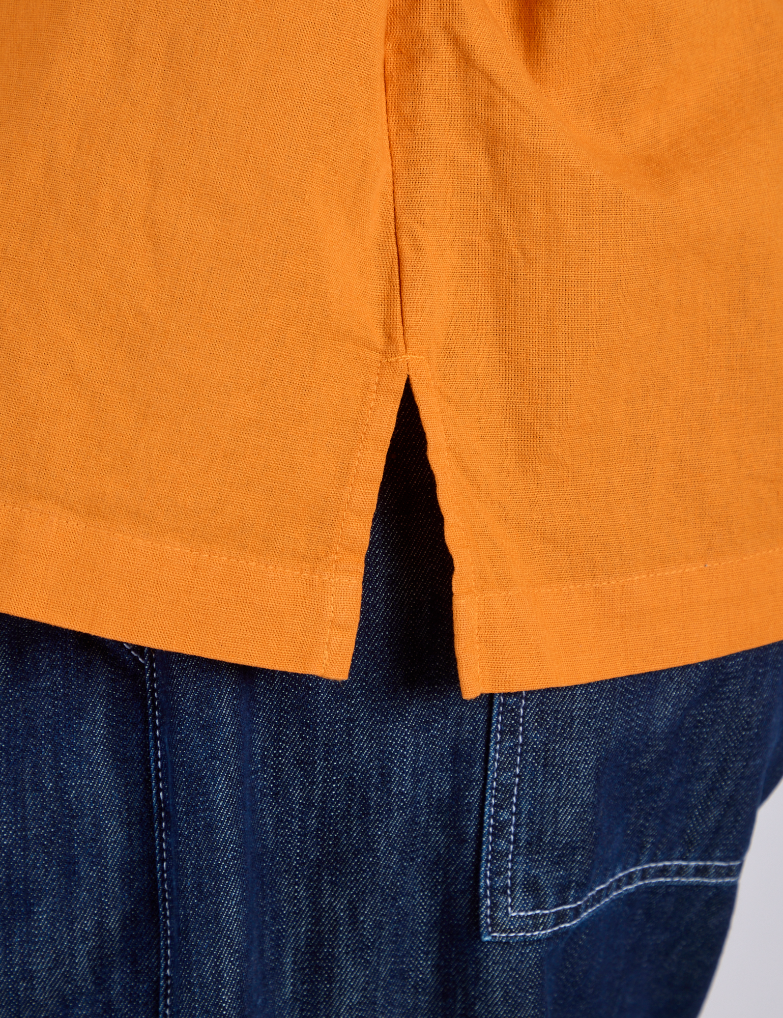 Close up of Pantry Button-Up in Creamsicle Orange side vent on Kira