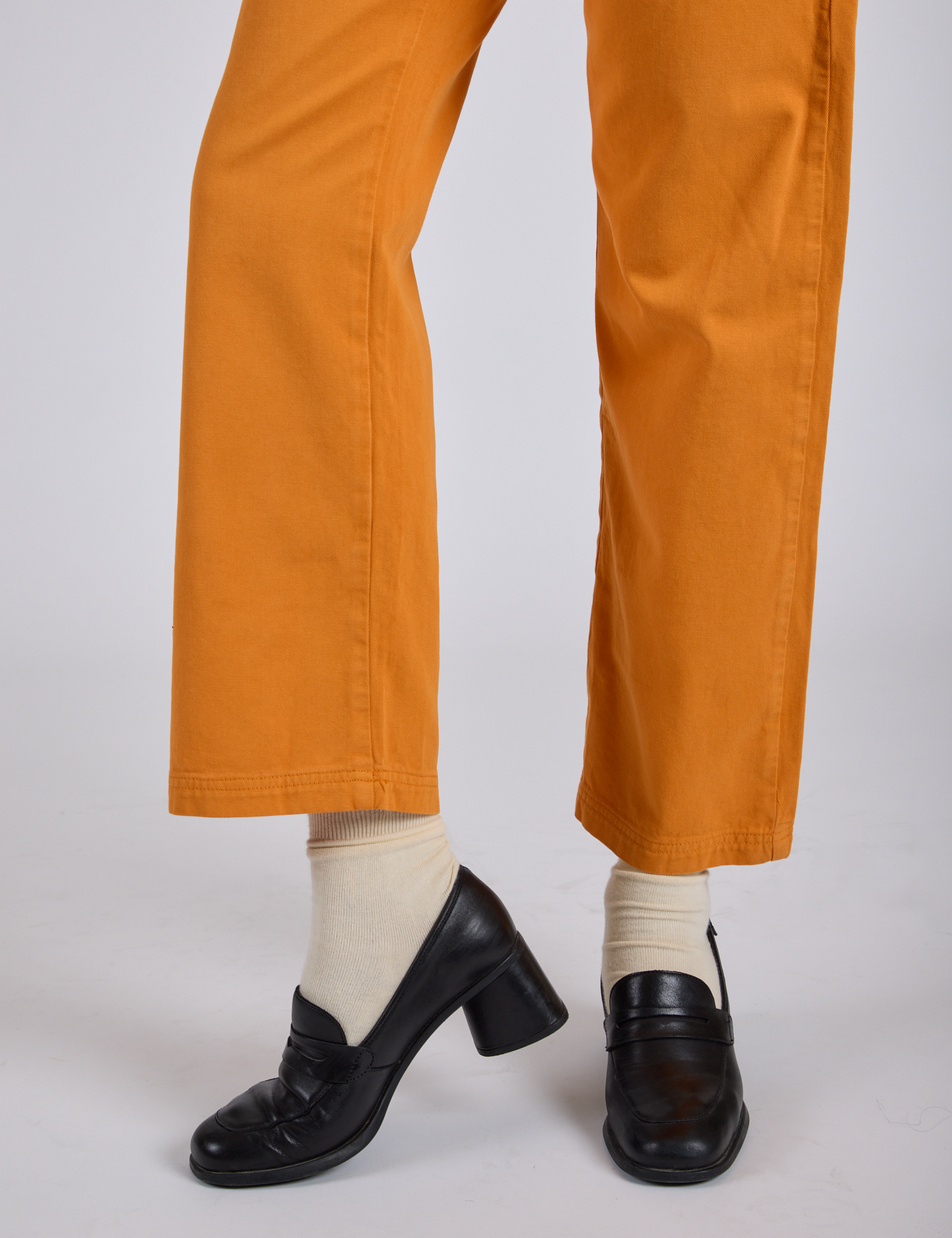 Work Pants in Creamsicle Orange pant leg close up on Kira
