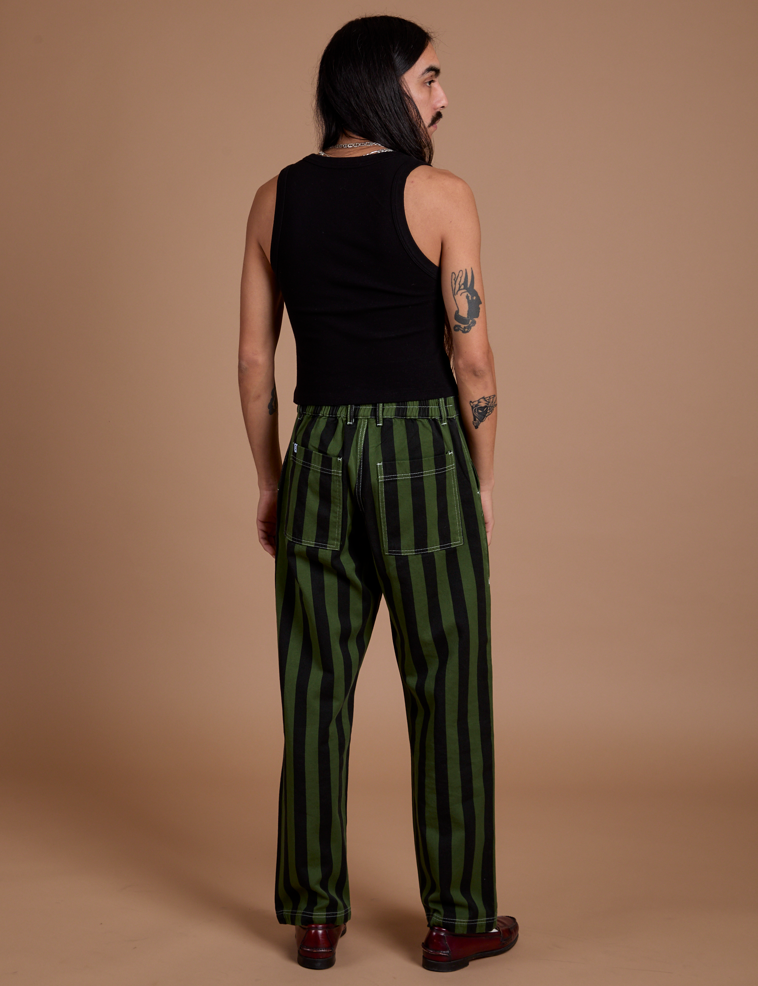 Back view of Black Stripe Work Pants in Evergreen and black Cropped Tank on Anthony
