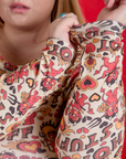 Long Sleeve Baby Tee in Hot Stuff Print sleeve close up on Juliet