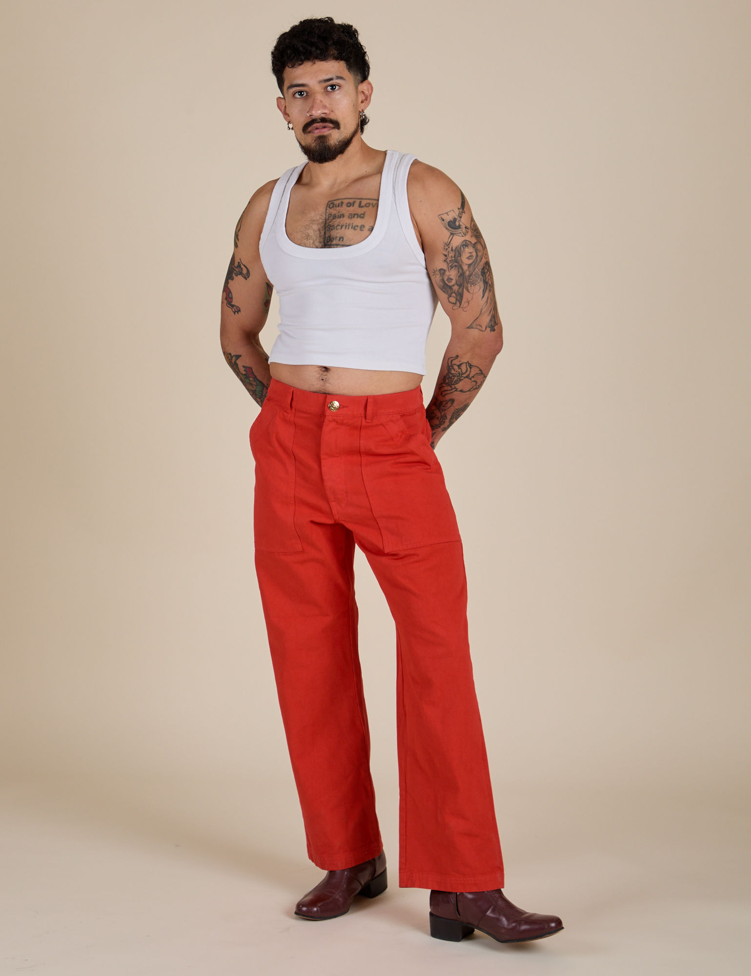Jesse is 5’8” and wearing S Work Pants in Mustang Red paired with a vintage tee white Cropped Tank
