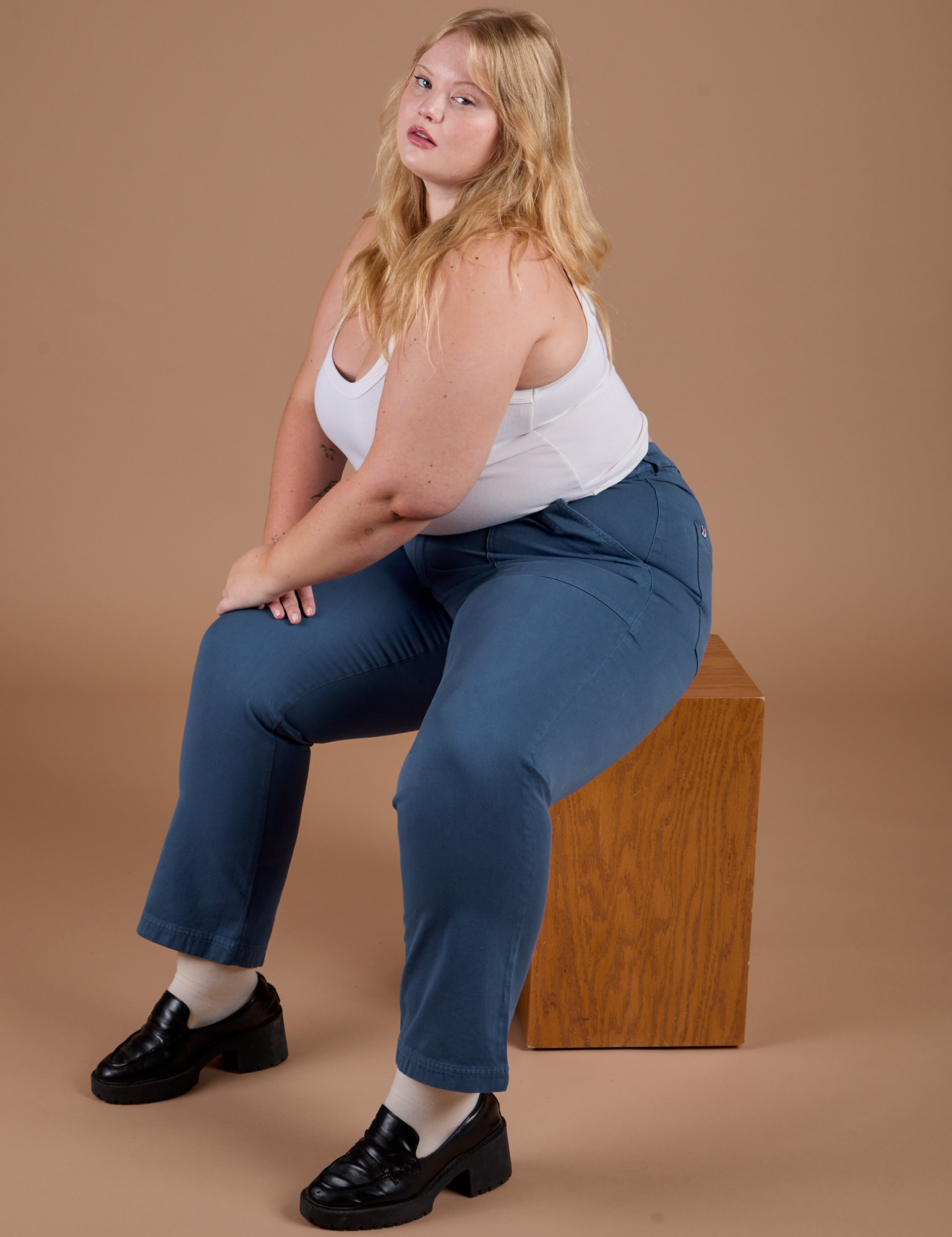 Juliet is wearing Organic Work Pants in French Blue and a vintage tee white Cropped Tank