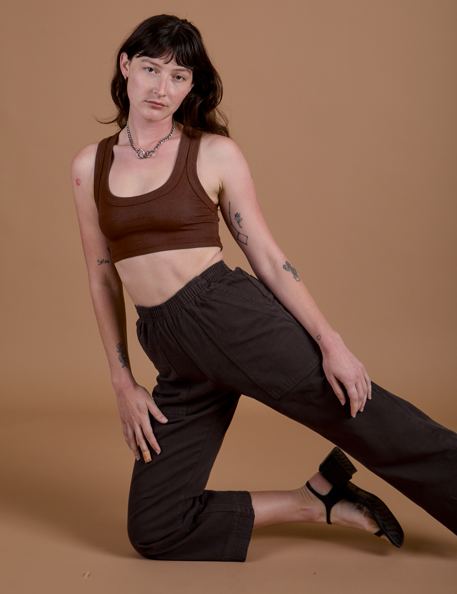 Alex is wearing Work Pants in Espresso Brown and Mini Tank in Fudgesicle Brown