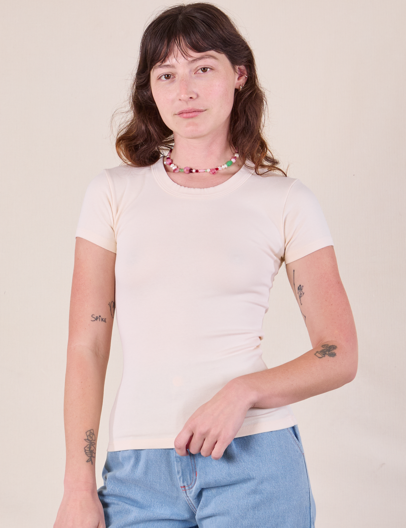 Alex is 5'8 and wearing P Baby Tee in Vintage Tee Off-White