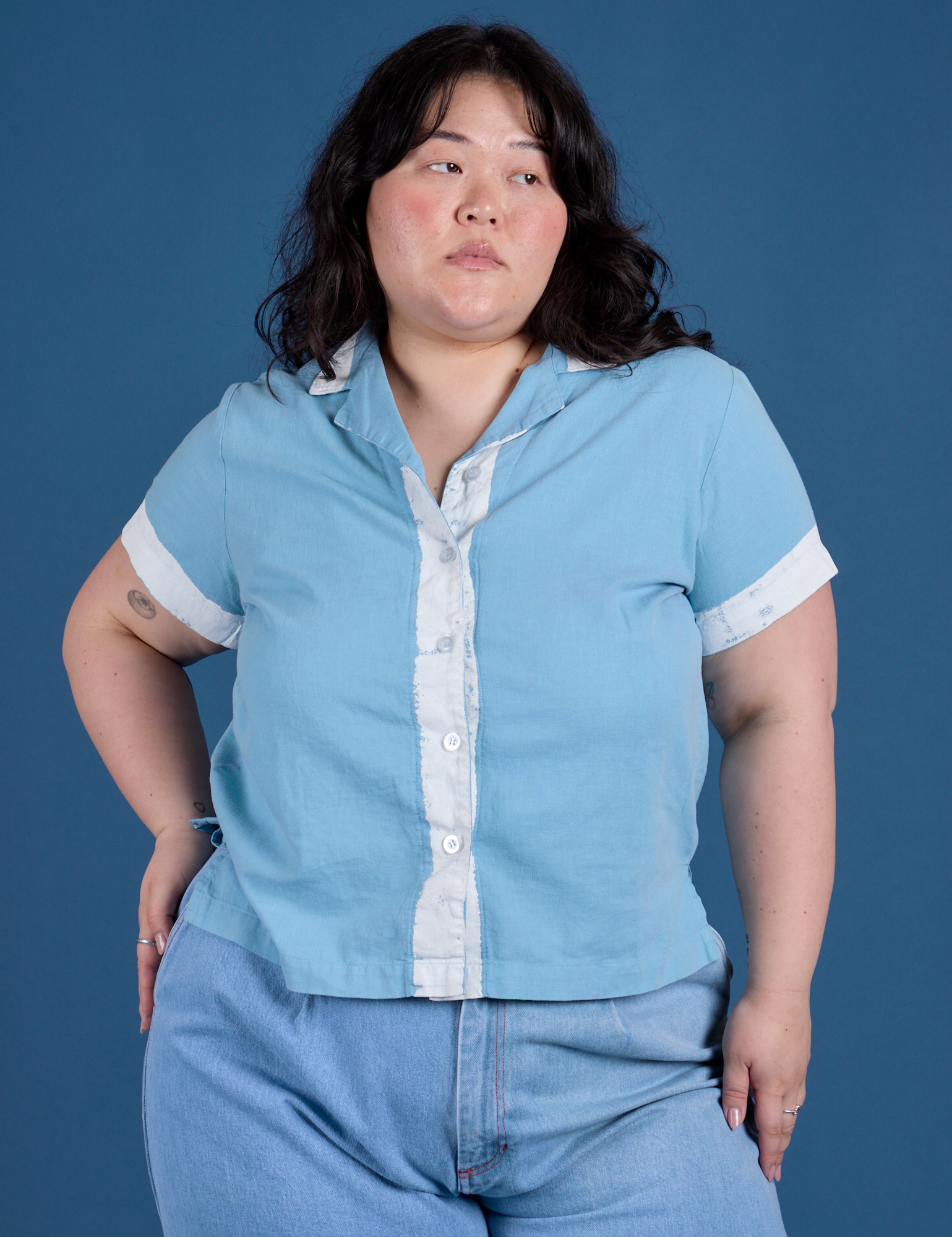 Ashley is wearing a buttoned up Painted Pantry Button-Up in Baby Blue