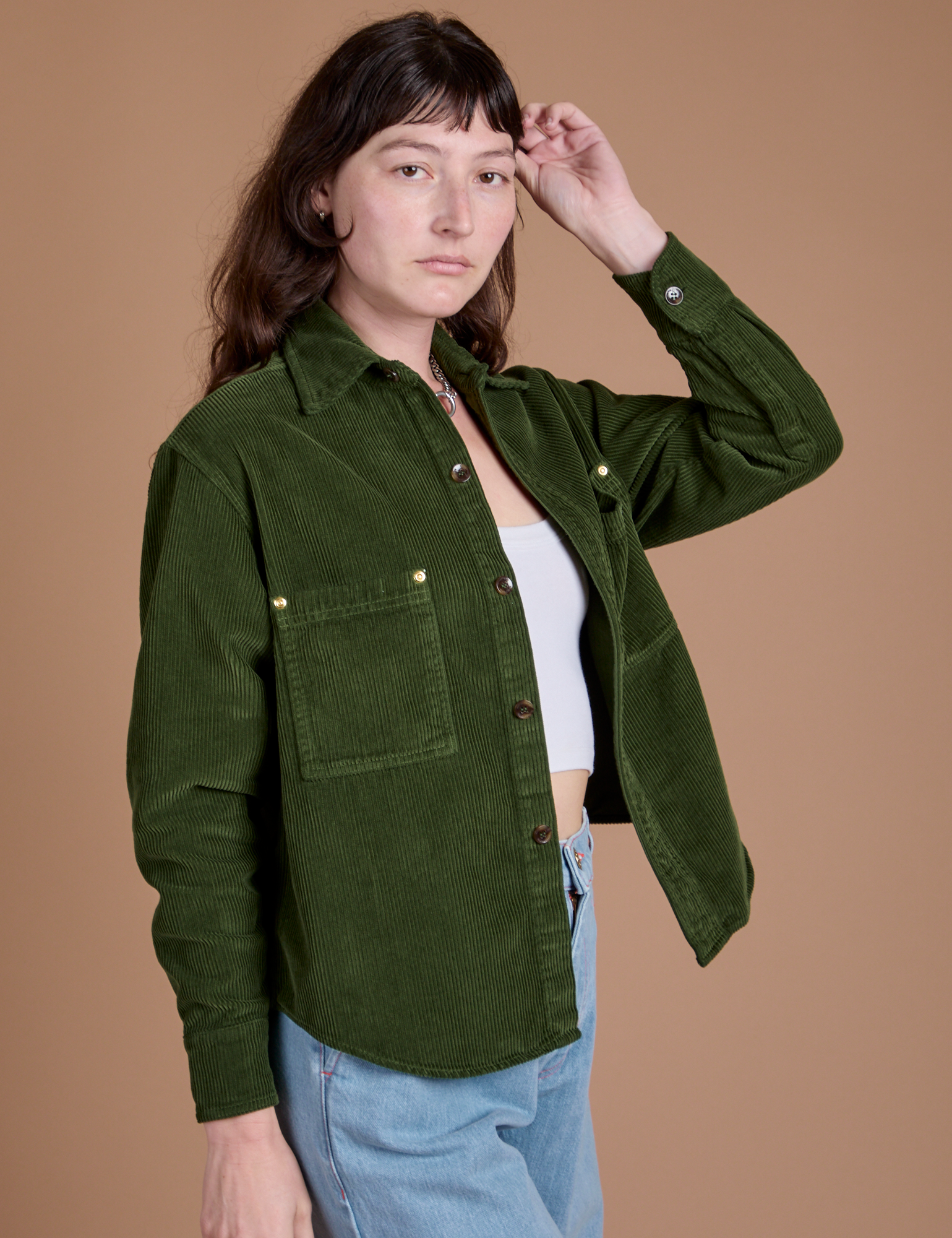 Angled front view of Cropped Corduroy Overshirt in Evergreen on Alex