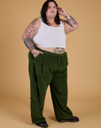 Angled front view of Corduroy Drop Pocket Cargo Pants in Evergreen and Cropped Tank in Vintage Tee White on Sam