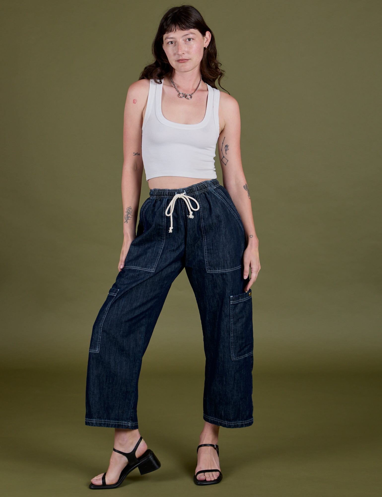 Alex is 5’8” and wearing XXS Denim Drop Pocket Pants in Dark Wash paired with a Cropped Tank in Vintage Tee White