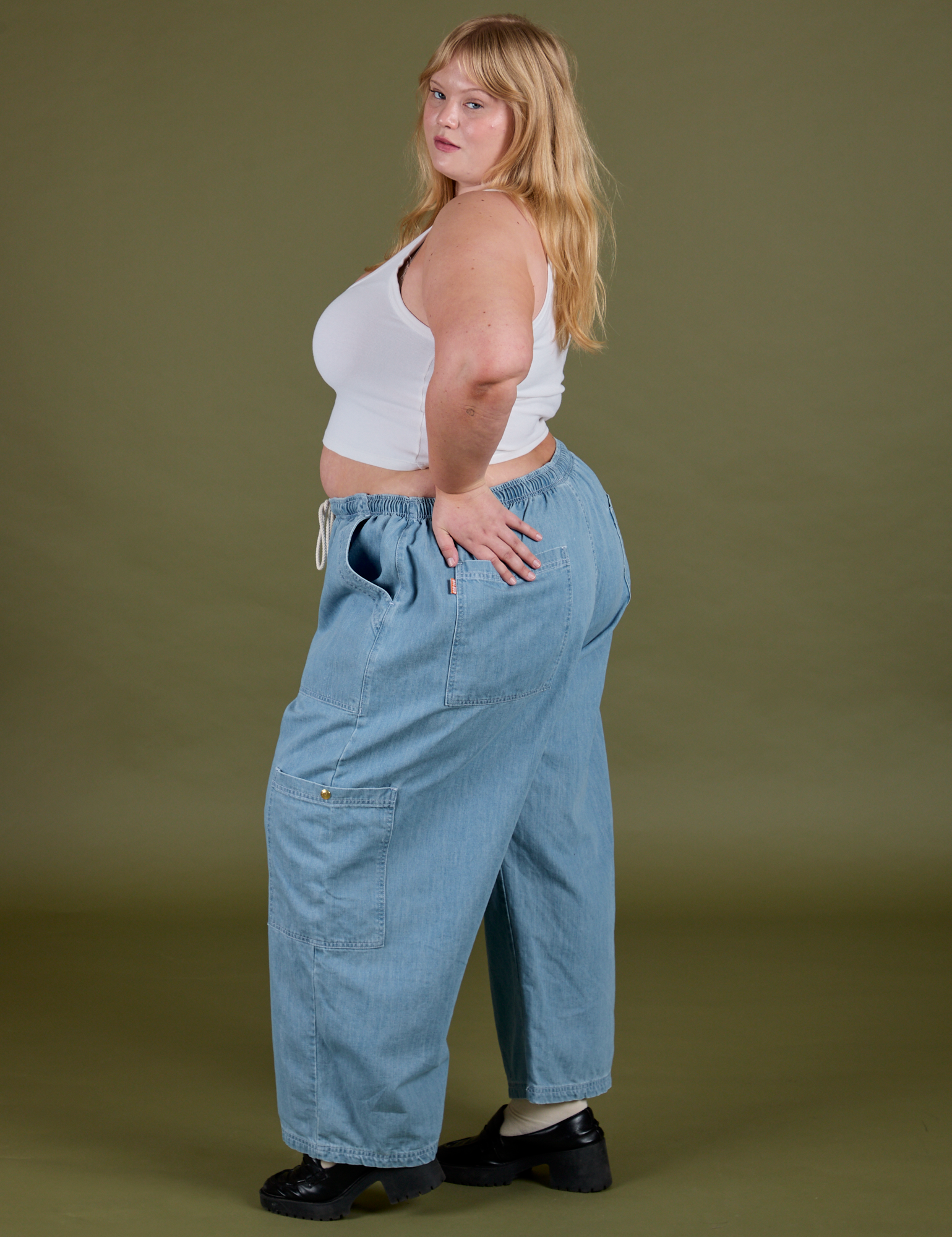 Side view of Denim Drop Pocket Pants in Light Wash and Cropped Tank in Vintage Tee White on Juliet