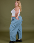 Side view of Denim Drop Pocket Pants in Light Wash and Cropped Tank in Vintage Tee White on Juliet