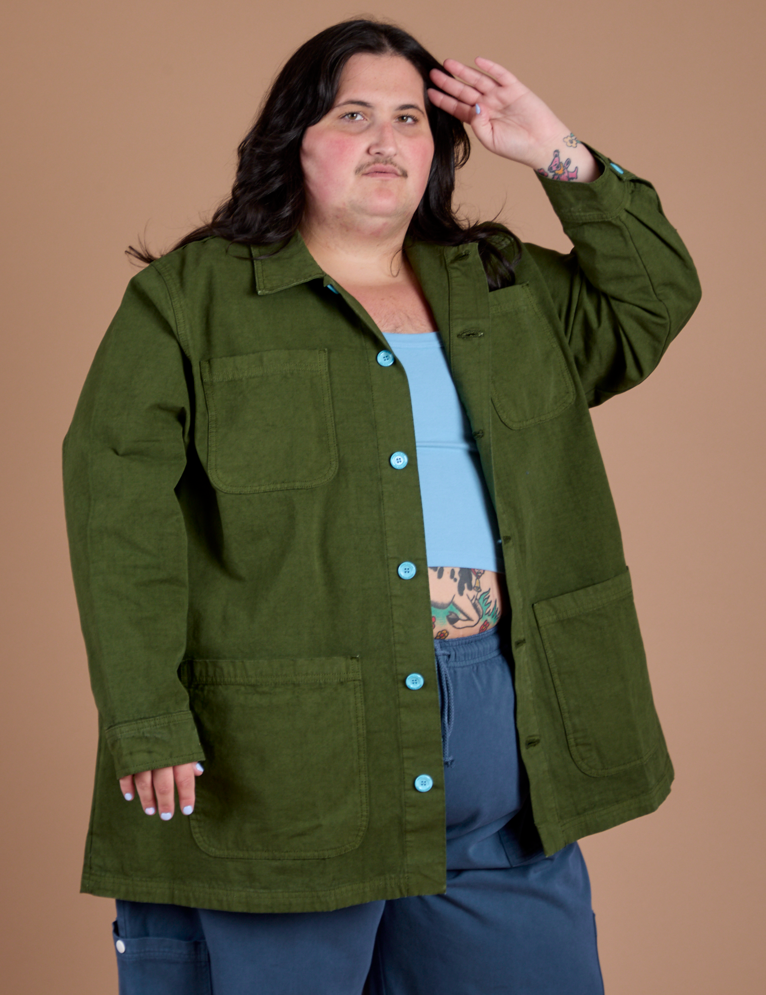 Angled front view of Ripstop Field Coat in Evergreen on Sam