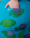 Close up of Ashley's hand in the back pocket of Paintstamped Work Pants in Lilypad