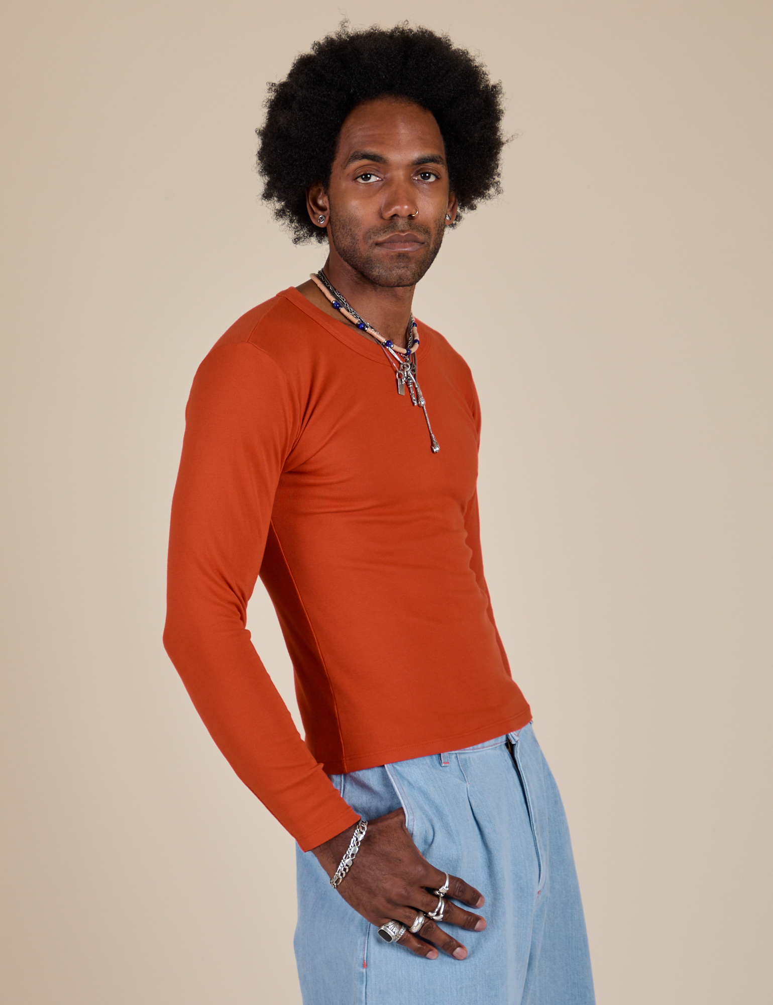 Long Sleeve Baby Tee in Chili Red side view on Jerrod