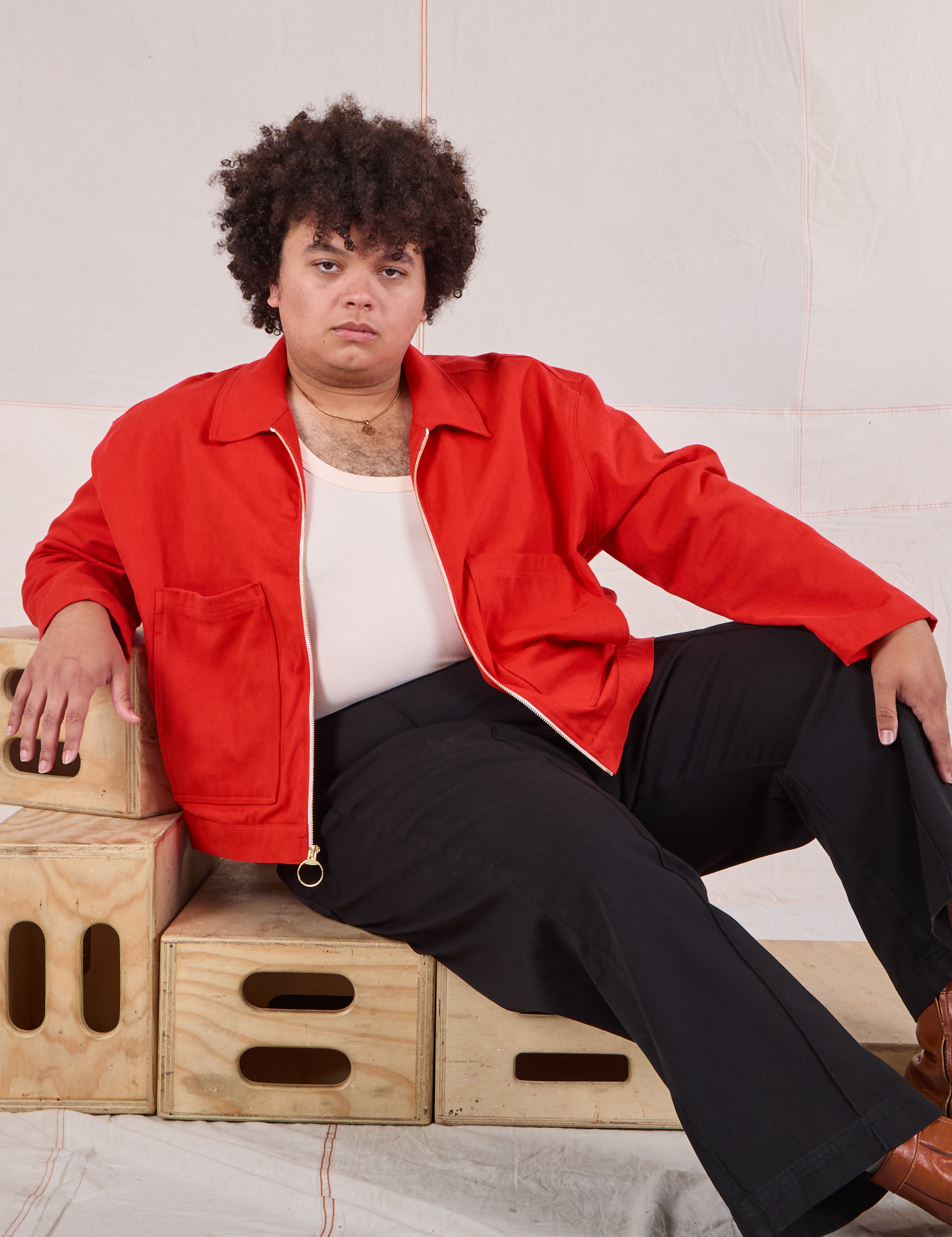 Miguel is wearing Mechanic Jacket in Mustang Red and black Western Pants