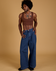 Jerrod is wearing Mini Tank in Fudgesicle Brown and dark wash Indigo Wide Leg Trousers