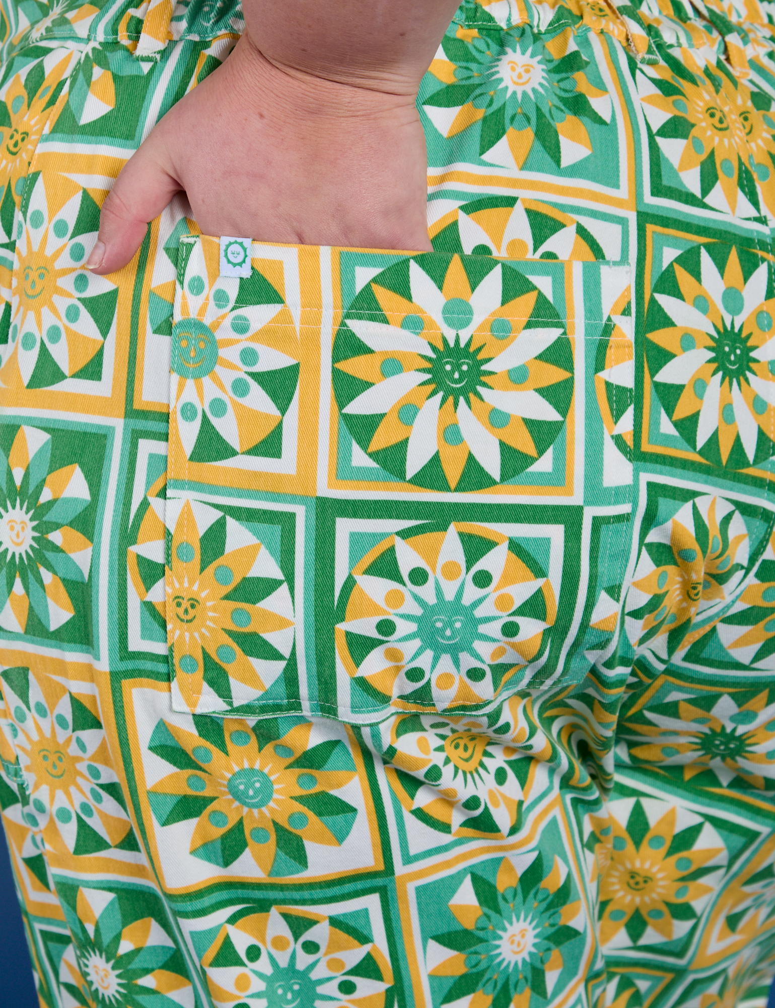 Close up of Juliet's hand in the back pocket of Spring Quilt Print Jumpsuit